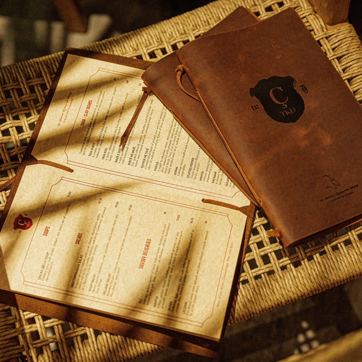 Rustic leather menu cover shown with its printed pages